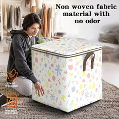 a woman sitting on the floor next to a large storage box