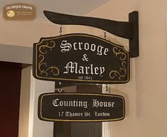 a sign hanging from the side of a building that says george & marley counting house