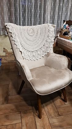 a white chair sitting on top of a hard wood floor