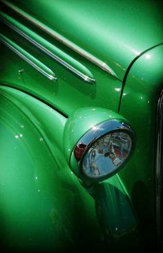 the front end of an old green car