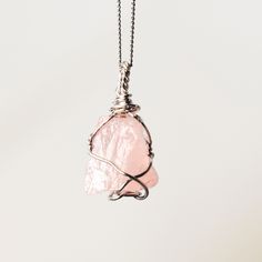 Rose Quartz Wire Wrapped Necklace  w 925 Sterling Silver Details: Gemstones: Rose Quartz Gemstone dimensions: 0.8"-1.2" (20-30 mm)  Material: 925 Sterling Silver Total necklace length: 16" /40 cm + extends to 18" /45 cm Rose Quartz, a gentle pink gem, embodies love and compassion. It resonates with the heart chakra, fostering emotional healing and self-love. Wearing Rose Quartz invites a sense of tenderness and inner harmony. ... Check out the full catalogue of raw wire wrapped crystal pendants Rose Gold Pendant Jewelry With Natural Stones, Rose Gemstone Jewelry As A Gift, Rose Gemstone Jewelry For Gift, Rose Gold Natural Stones Pendant Jewelry, Rose Gold Crystal Necklaces With Rose Quartz Gemstone, Pink Jewelry With Natural Stones Gift, Rose Pendant Jewelry For Her, Rose Gold Pendant With Natural Stones, Pink Minimalist Sterling Silver Jewelry