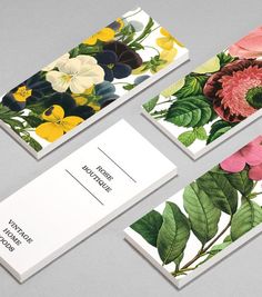 four business cards with flowers and leaves on them, all printed in different colors from pink to yellow