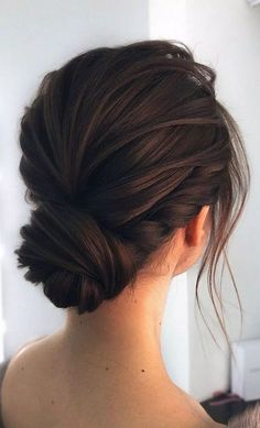 a woman with her hair in a low bun