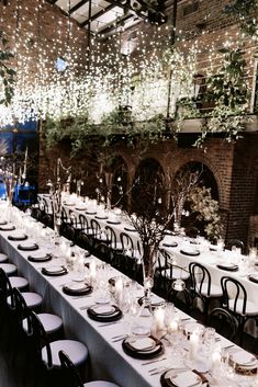 the tables are set with white tablecloths and place settings for an elegant dinner