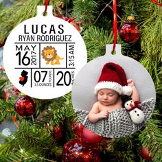 a baby's first christmas ornament hanging from a tree with a lion on it