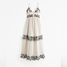 Nwt Abercrombie & Fitch Tiered Maxi Dress. Smocked In Back, Straps Adjust With Ties In Back, Has Pockets And Asymmetrical Hem. Tan With Black Embroidered Floral Pattern. No Trades Please, Bundle And Save. Flattering Maxi Dress, Female Features, Ruffle Maxi Dress, Flowy Fabric, Grey Maxi Dress, Embroidered Details, Cotton Embroidery, Tiered Maxi Dress, Ruffled Maxi Dress