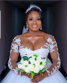 a woman in a wedding dress holding a bouquet