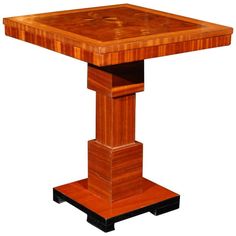 a square wooden table with two legs on one side and an end section at the top