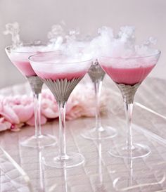 three martini glasses filled with pink liquid