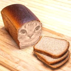 a loaf of bread sitting on top of a wooden cutting board next to a slice of bread