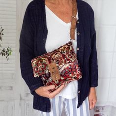 an older woman holding a purse in her hands