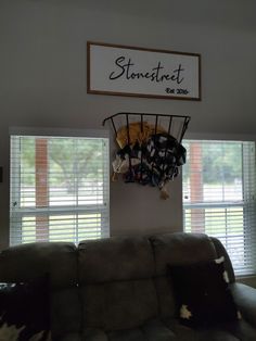 a living room filled with furniture and a sign above the window that says stone street