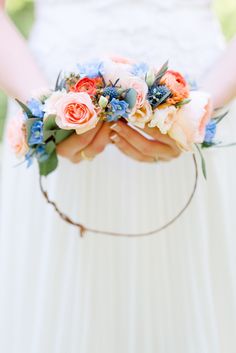 the bride is holding her bouquet in her hands