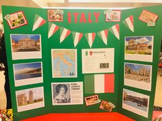 a display with pictures and information about italy on it's green board, in the middle of a room filled with people