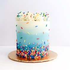 a birthday cake with sprinkles and white frosting