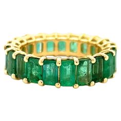 Amazing hand crafted 18k yellow gold Colombian Emerald eternity band. This ring is truly breathtaking. Each stone was matched to perfection to create this one of a kind ring. Twenty one Emeralds are set into this band, all showing a vibrant green color. Ring has a 7.31 Tcw. To find matching Emeralds with the same color and clarity is extremely rare, making this ring a true one of a kind item. This ring is a size 6.25, however minimal sizing is available upon request. All photos taken under magni Emerald Green Eternity Band, Colombian Emeralds, Fancy Jewellery, Pave Ring, Vibrant Green, Color Ring, Green Emerald