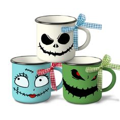 three coffee mugs decorated to look like jack - o - lantern faces with bows