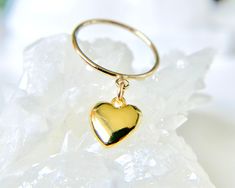 This 14K Gold-Filled Heart Charm Ring features a puffy dangling heart, making it a perfect romantic gift for her. It's handcrafted with a choice of a textured, smooth or thin band and is available in custom sizes 4, 5, 6, 7 and 8.  It makes a perfect friendship or promise ring. ✦100% handcrafted ✦ High quality 14K gold-filled metal ✦ Ring arrives in either a pink microfiber suede envelope/pouch or a blue/green drawer cardboard box as seen in the last image of this listing. ✦ Ready to ship in one Green Drawer, Layering Rings, Dainty Designs, Envelope Pouch, Heart Rings, Gold Heart Ring, Charm Ring, Romantic Gifts For Her, Layered Rings