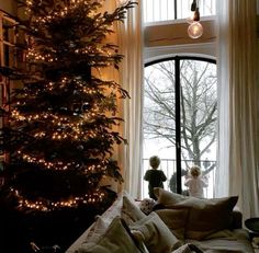 a living room with a christmas tree in the corner