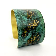 These unique, hand-formed copper and brass cuff bracelets with vibrant patinas create stunning accents to your personal style. Dress up or down- either way you'll be wearing an adornment that will turn heads, start conversations, and delight the eye of the beholder. Hammered Brass cuff with bright brass peeking through a lovely marbled green/blue patina. Please note that patina colors will look different depending on the screen/device you view them on. This is a medium cuff- see measurements bel Green Patina Bangle Bracelet, Green Bangle Bracelets With Patina, Bronze Wearable Art Cuff Bracelet As Gift, Bronze Bangle Bracelet With Patina, Green Patina Cuff Bracelet Gift, Green Patina Cuff Bracelet As Gift, Bronze Bangle Bracelet In Wearable Art Style, Adjustable Patina Bangle As Gift, Brass Cuff Bracelet With Patina As A Gift