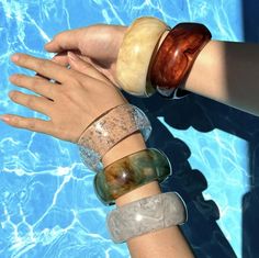 Step into summer with our Statement Vintage Chunky Bangles! Crafted from colourful irregular acrylic resin, each bangle is a unique geometric masterpiece, reminiscent of retro charm. The tortoiseshell design adds a touch of timeless elegance, perfect for those sunny summer days. Whether you're lounging by the pool or strolling along the beach, these bracelets are the ultimate accessory for adding a pop of colour to any outfit. Embrace your individuality and elevate your style with our vibrant an Trendy Plastic Bangle Jewelry, Trendy Clear Resin Jewelry, Plastic Jewelry For Summer Beach, Handmade Plastic Jewelry For The Beach, Trendy Summer Plastic Jewelry, Green Plastic Summer Jewelry, Summer Party Clear Jewelry, Adjustable Resin Bangle Jewelry, Trendy Summer Bangle Jewelry