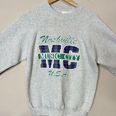 "Vintage 90s Nashville Music City USA Gray long sleeved cotton sweatshirt by Fruit of the Loom. Heather gray heavy 100% cotton  Great vintage condition  Small stain on back of left sleeve Marked size L please check measurements below. Measurements  Pit to pit21.5\" Sleeve24\" measured from middle of back of collar to cuff. Length32\" measured from middle of back of collar to hem. I recently had a customers package stolen from their porch. I can not be responsible for package once it's in possess Long Sleeve Tshirts, Dark Blue Sweatshirt, Black Leather Motorcycle Jacket, Nashville Music, Music City Nashville, Black Leather Oxfords, Usa Sweatshirt, Vintage Usa, Blue Sweatshirt