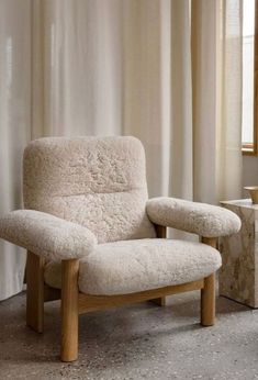 a chair and ottoman in front of a window