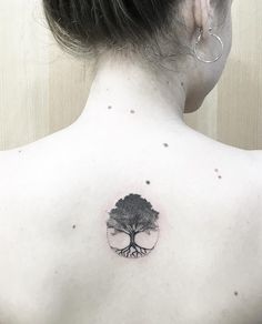 a woman with a tree tattoo on her back