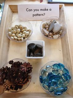 three bowls filled with different types of rocks on a wooden tray next to a sign that says can you make a pattern?