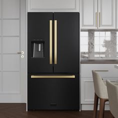 a black refrigerator with gold accents in a kitchen