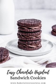 a stack of chocolate cookies sitting on top of a white plate