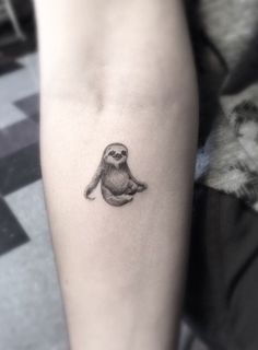 a small bird tattoo on the arm