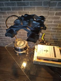 a table topped with books and a metal object on top of it's side