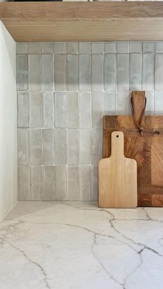 a cutting board sitting on top of a kitchen counter next to a knife and block