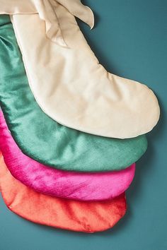 five different colored pillows stacked on top of each other