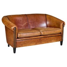 a brown leather couch with black legs on a white background