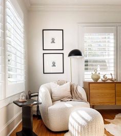 a living room filled with furniture and pictures on the wall