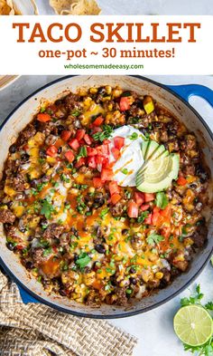 a skillet filled with taco skillet, tortilla chips and sour cream