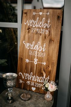 a wooden sign sitting on top of a table