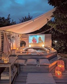 a hot tub sitting on top of a wooden deck next to a patio with lights