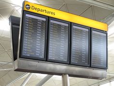 an airport check - in counter with the departures listed on it's side