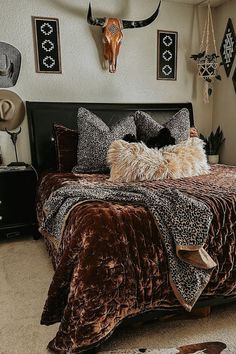 a bed room with a neatly made bed and animal prints