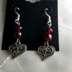 Add A Touch Of Elegance To Your Look With These One Of A Kind Handmade Beautiful Garnet And Red Crystal Silver Heart Earrings. The Red Crystal Beads And Garnet Stones Are Perfectly Complemented By The Tibetan Silver Metal, Creating A Stunning Piece Of Jewelry That Is Sure To Turn Heads. The Earrings Feature A Beaded Dangle/Drop Style That Will Add A Touch Of Sophistication To Any Outfit. They Have 925 Silver Backings. These Earrings Are Perfect For Any Occasion, From A Night Out On The Town To A Silver Beaded Heart Earrings Gift, Red Metal Heart Earrings For Party, Minnie Mouse Earrings, Silver Heart Earrings, Garnet Red, Stone Dangle Earrings, Faux Pearl Earrings, Costume Earrings, Square Earrings Studs