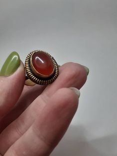 Solid brass with carnelian stone verry beautiful old ring Vintage Red Oval Cabochon Signet Ring, Vintage Opal Ring Gift, Vintage Red Signet Ring With Oval Cabochon, Vintage Bronze Handmade Rings, Vintage Round Cabochon Moonstone Ring, Handmade Vintage Moonstone Ring, Vintage Brown Hallmarked Ring, Brown Hallmarked Vintage Ring, Vintage Round Ruby Ring