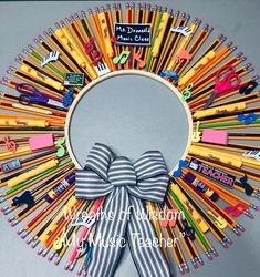 a wreath made out of pencils with a bow on the front and back side