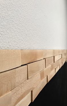 a close up view of a fireplace with wood blocks on the mantle and wall behind it