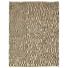 a brown and white area rug with squares on it, in the shape of an abstract pattern