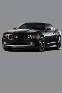 a black chevrolet camaro is shown from the side