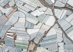 an aerial view of several rows of greenhouses