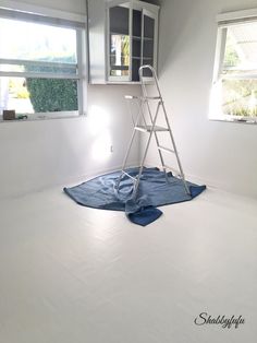 a ladder is in the middle of a white room